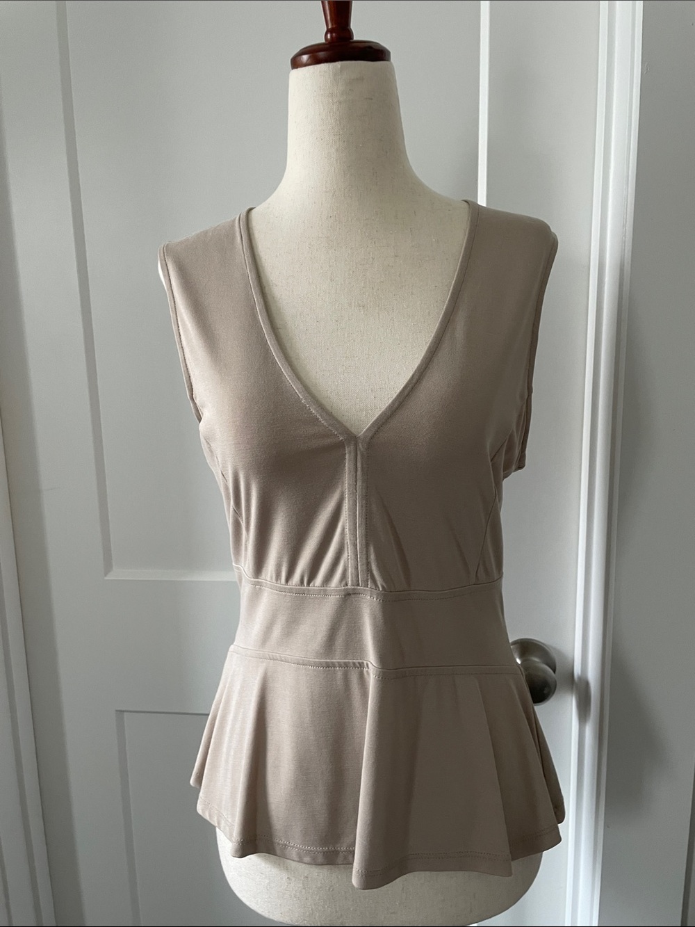 BCBGMaxAzria Sleeveless V-Neck Peplum Top in Beige